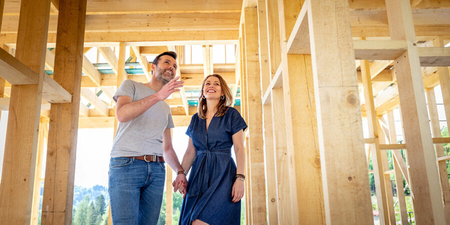Happy couple touring home in development